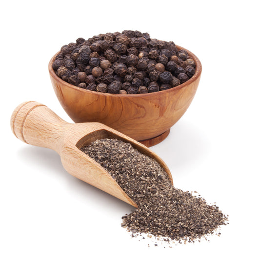 Black pepper powder with whole peppercorns in a wooden bowl and scoop, showing the fresh, natural quality of Mantra Herbs spice