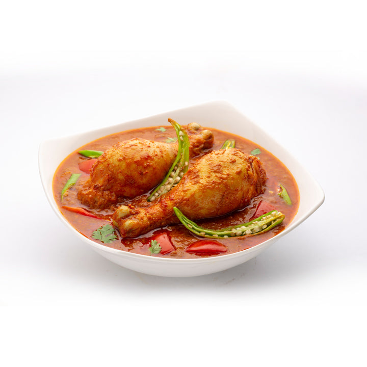 Kerala-style chicken curry served in a white bowl, prepared using Mantra Herbs Chicken Masala – homemade natural spice blend for authentic flavour