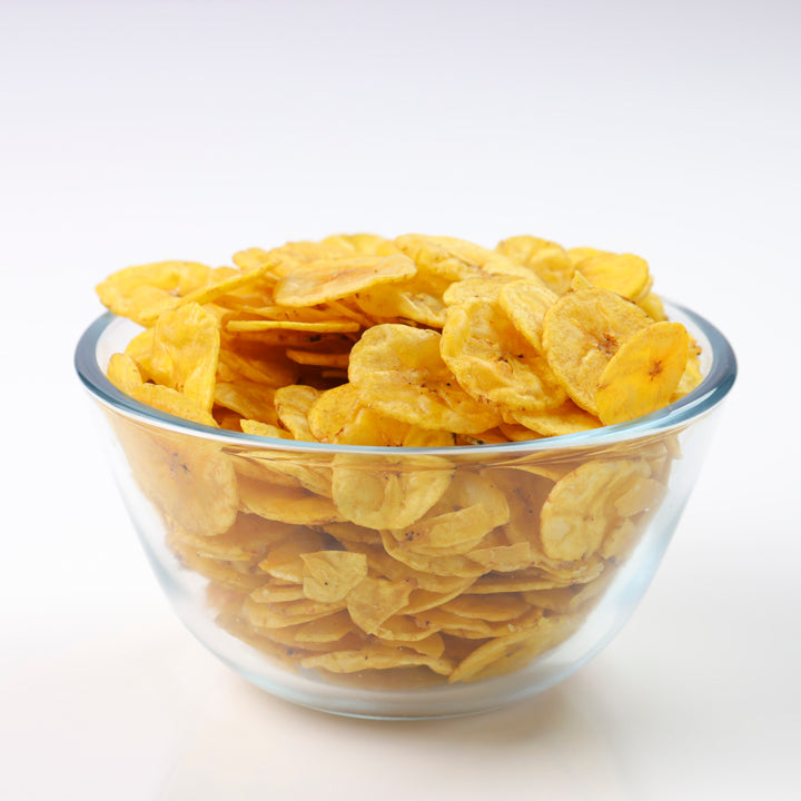 Fresh Kerala banana chips in a glass bowl, crispy and golden, fried in pure coconut oil by Mantra Herbs