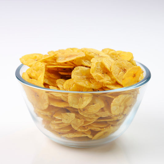 Fresh Kerala banana chips in a glass bowl, crispy and golden, fried in pure coconut oil by Mantra Herbs