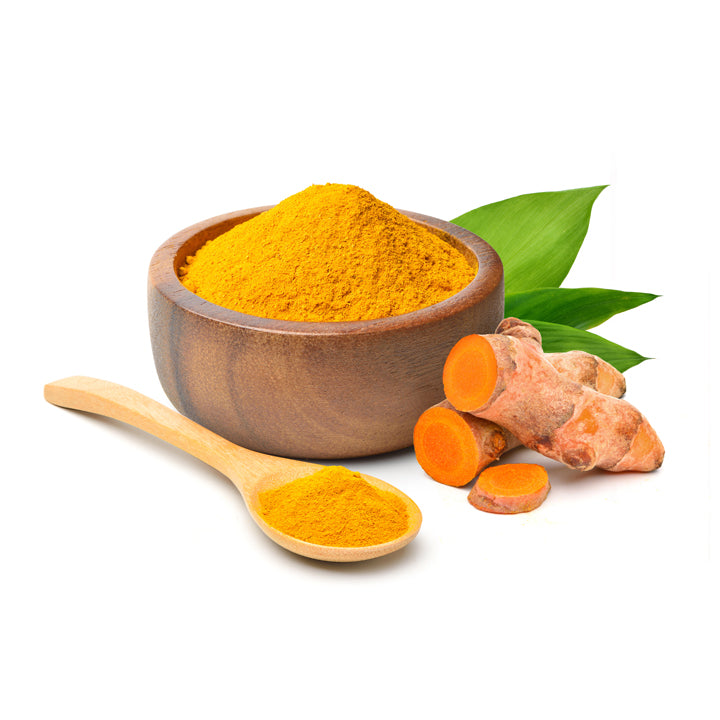 Turmeric powder in a wooden bowl with sliced fresh turmeric roots and a wooden spoon, showing the natural homemade quality of Mantra Herbs spice.